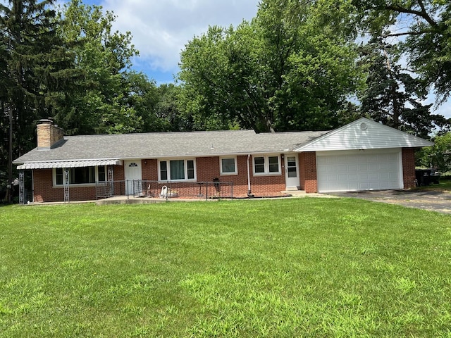 1006 Maple Hill Rd, Bloomington, IL 61705 - ranch-style house with a garage, driveway, brick siding, and a front yard