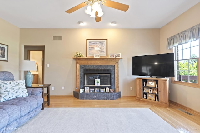 3710 W Nettle Creek Dr, Morris, IL 60450 - living area featuring a ceiling fan, wood finished floors, and a glass covered fireplace