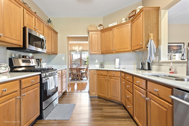 3710 W Nettle Creek Dr, Morris, IL 60450 - kitchen with stainless steel appliances, light countertops, dark wood-style floors, and tasteful backsplash