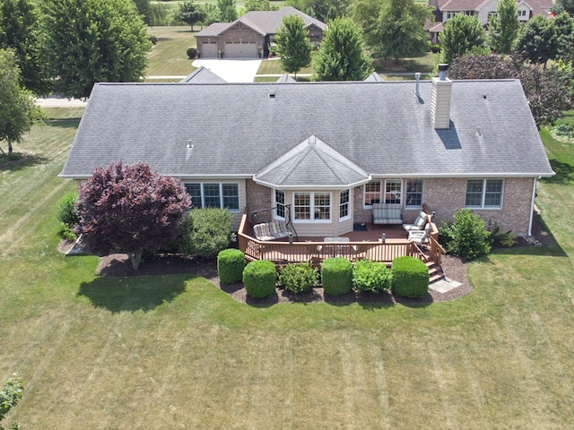 3710 W Nettle Creek Dr, Morris, IL 60450 - back of house with a chimney, a deck, a lawn, and brick siding