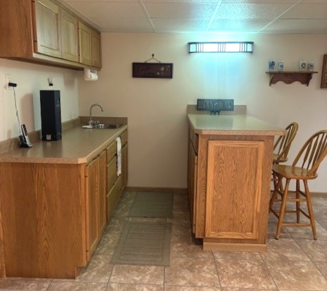 3710 W Nettle Creek Dr, Morris, IL 60450 - kitchen featuring a kitchen breakfast bar, light countertops, a peninsula, and brown cabinets