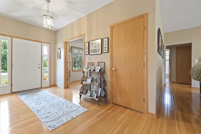 3710 W Nettle Creek Dr, Morris, IL 60450 - foyer entrance with light wood-style floors, plenty of natural light, and a chandelier