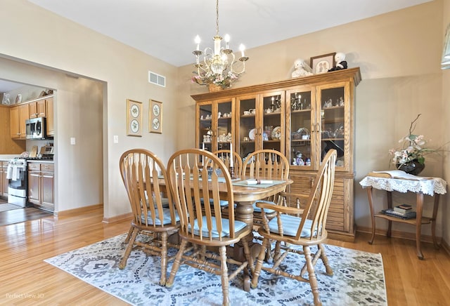 3710 W Nettle Creek Dr, Morris, IL 60450 - dining room with a chandelier and light wood finished floors