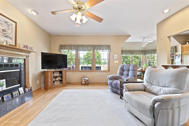 3710 W Nettle Creek Dr, Morris, IL 60450 - living area with ceiling fan, wood finished floors, plenty of natural light, a premium fireplace, and recessed lighting