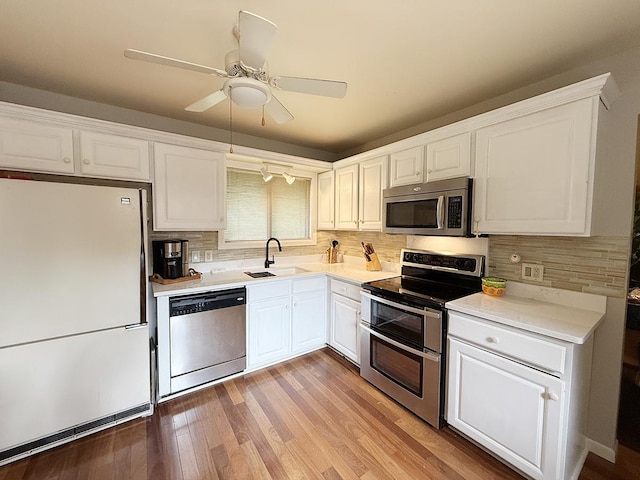 42W396 Hawthorne Ct, Saint Charles, IL 60175 - kitchen with stainless steel appliances, white cabinetry, tasteful backsplash, light countertops, and light wood-style flooring