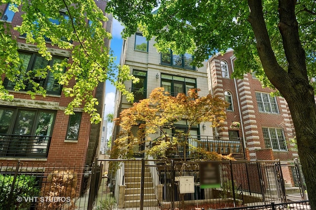 2145 W Crystal St Unit 2, Chicago, IL 60622 - view of front of home featuring a fenced front yard and brick siding
