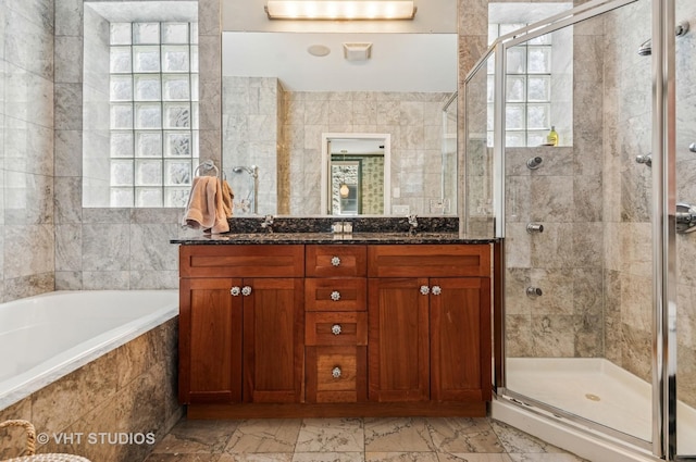 2145 W Crystal St Unit 2, Chicago, IL 60622 - bathroom featuring a shower stall, double vanity, a bath, marble look tiles, and tile walls