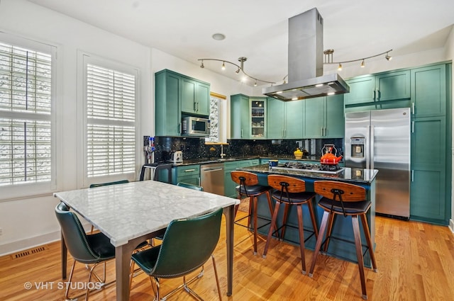2145 W Crystal St Unit 2, Chicago, IL 60622 - kitchen with green cabinetry, island exhaust hood, stainless steel appliances, and plenty of natural light