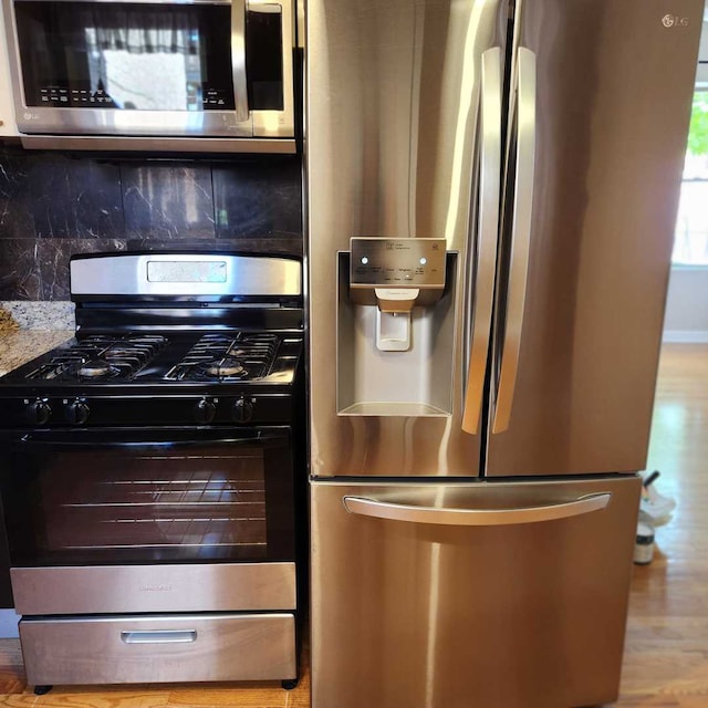 3700 W Cermak Rd Unit 1, Chicago, IL 60623 - kitchen with appliances with stainless steel finishes, decorative backsplash, and wood finished floors