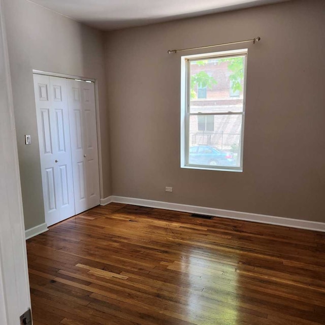 3700 W Cermak Rd Unit 1, Chicago, IL 60623 - unfurnished bedroom featuring dark wood-type flooring and a closet