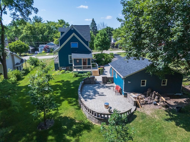241 Hoy Ave, Woodstock, IL 60098 - rear view of house featuring roof with shingles, a lawn, and a wooden deck