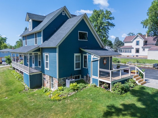 241 Hoy Ave, Woodstock, IL 60098 - rear view of property with a shingled roof, a lawn, and a wooden deck