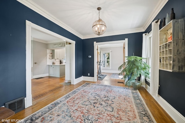 241 Hoy Ave, Woodstock, IL 60098 - foyer entrance with a chandelier, ornamental molding, and wood finished floors