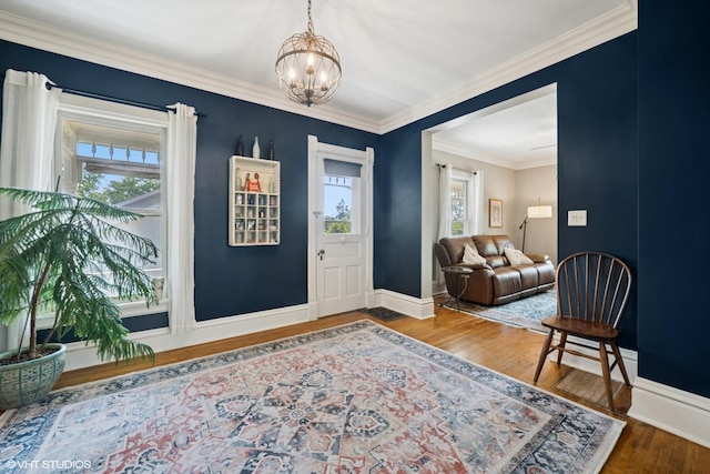 241 Hoy Ave, Woodstock, IL 60098 - foyer with plenty of natural light, a chandelier, wood finished floors, and crown molding