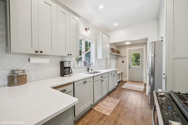 241 Hoy Ave, Woodstock, IL 60098 - kitchen featuring stainless steel appliances, wood finished floors, backsplash, light countertops, and recessed lighting