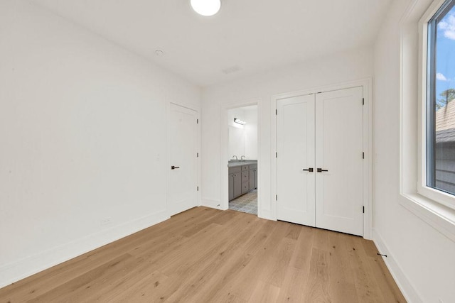 2248 W Ainslie St, Chicago, IL 60625 - unfurnished bedroom with light wood-type flooring and connected bathroom