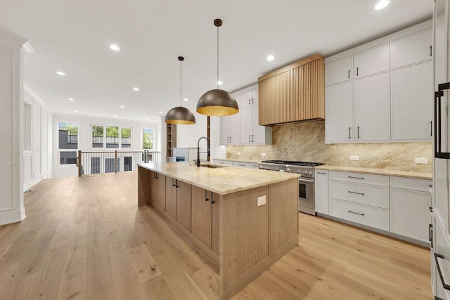 2248 W Ainslie St, Chicago, IL 60625 - kitchen with high end stainless steel range, backsplash, light wood-style floors, recessed lighting, and light stone counters