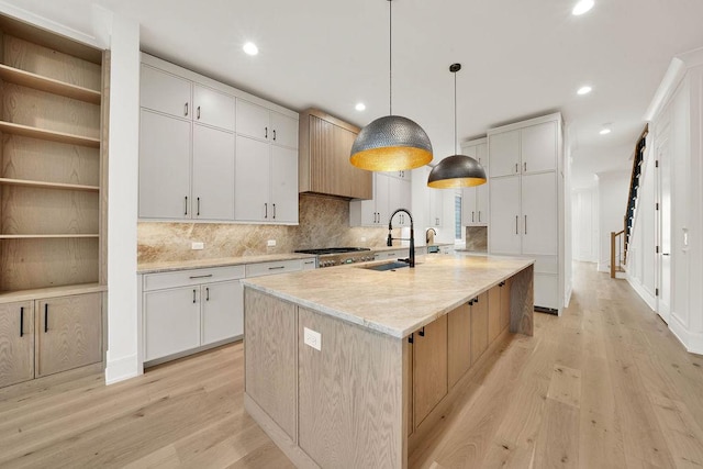 2248 W Ainslie St, Chicago, IL 60625 - kitchen with light wood-style floors, tasteful backsplash, recessed lighting, a large island, and white cabinets