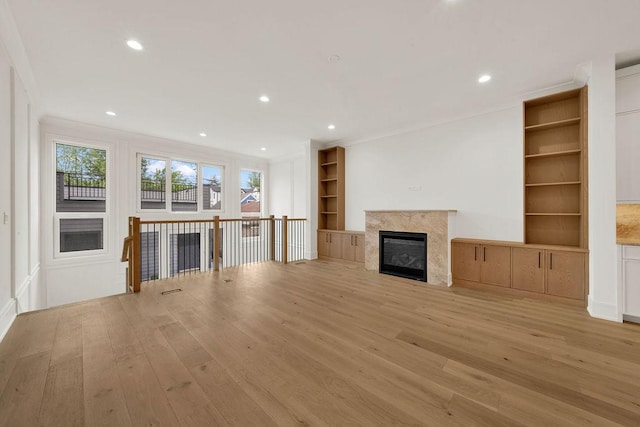 2248 W Ainslie St, Chicago, IL 60625 - unfurnished living room with light wood finished floors, built in features, recessed lighting, a high end fireplace, and ornamental molding