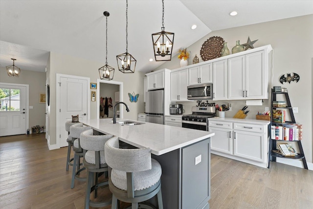 1807 E Fairfield Cir, Urbana, IL 61802 - kitchen featuring stainless steel appliances, a chandelier, lofted ceiling, a center island with sink, and a breakfast bar