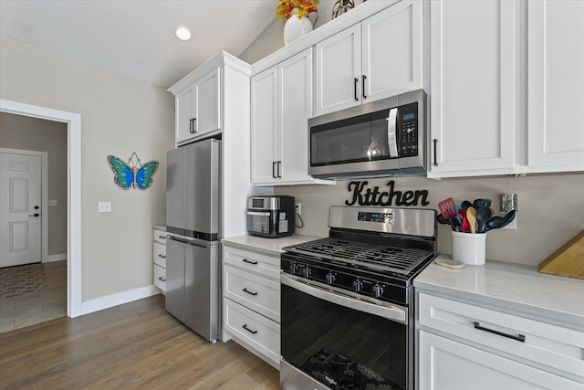 1807 E Fairfield Cir, Urbana, IL 61802 - kitchen featuring stainless steel appliances, white cabinets, recessed lighting, light wood-style floors, and light stone countertops