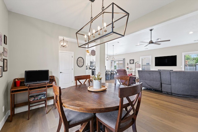 1807 E Fairfield Cir, Urbana, IL 61802 - dining room featuring wood finished floors, ceiling fan, and a chandelier