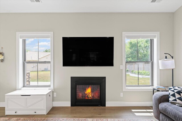 1807 E Fairfield Cir, Urbana, IL 61802 - living area featuring wood finished floors, healthy amount of natural light, and a lit fireplace