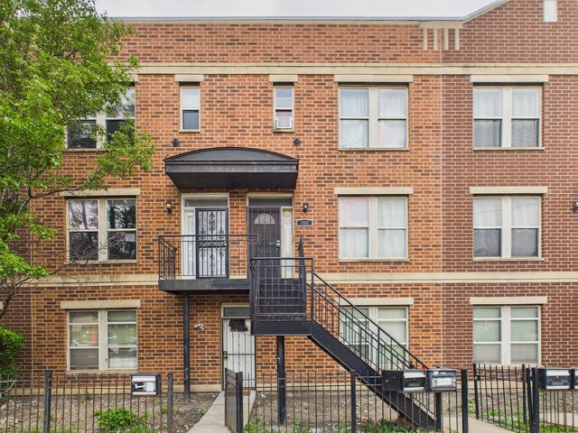 738 S Kedzie Ave Unit 3, Chicago, IL 60612 - view of property with a fenced front yard and cooling unit