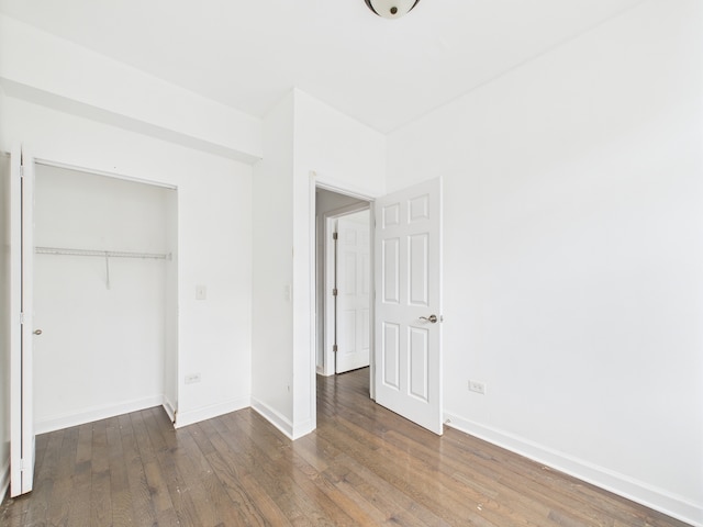 738 S Kedzie Ave Unit 3, Chicago, IL 60612 - unfurnished bedroom featuring wood-type flooring and a closet