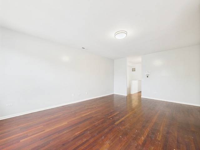 738 S Kedzie Ave Unit 3, Chicago, IL 60612 - spare room featuring dark wood-style flooring and baseboards
