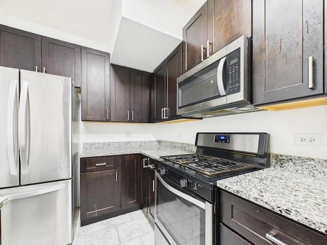 738 S Kedzie Ave Unit 3, Chicago, IL 60612 - kitchen featuring stainless steel appliances, light marble finish flooring, dark brown cabinets, and light stone countertops