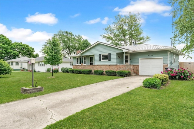 405 E Madison St, Pesotum, IL 61863 - single story home with an attached garage, brick siding, concrete driveway, a front yard, and a standing seam roof