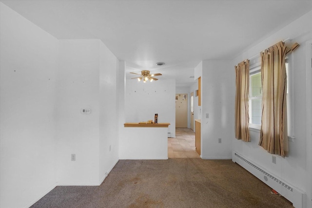 405 E Madison St, Pesotum, IL 61863 - unfurnished room with a baseboard heating unit, light colored carpet, and ceiling fan