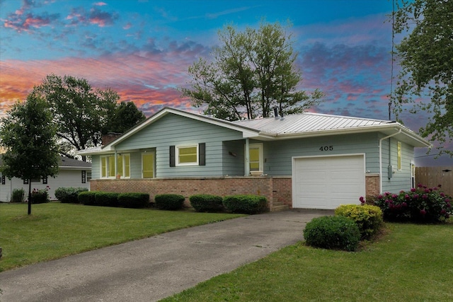 405 E Madison St, Pesotum, IL 61863 - ranch-style house featuring brick siding, a garage, concrete driveway, and a front lawn