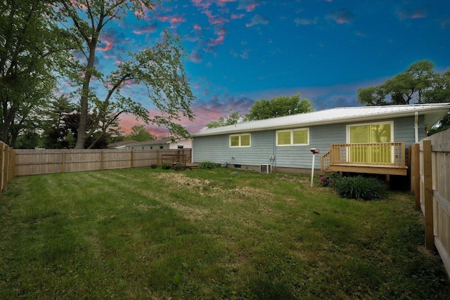 405 E Madison St, Pesotum, IL 61863 - back of house at dusk featuring a fenced backyard, a metal roof, and a deck