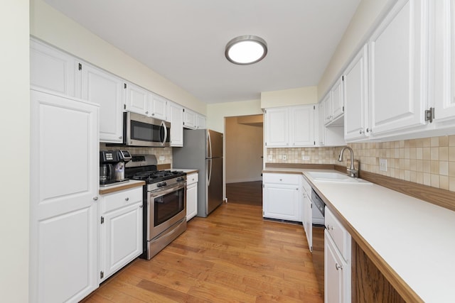 12912 Mill Dr E, Palos Park, IL 60464 - kitchen with stainless steel appliances, white cabinets, and light wood-type flooring