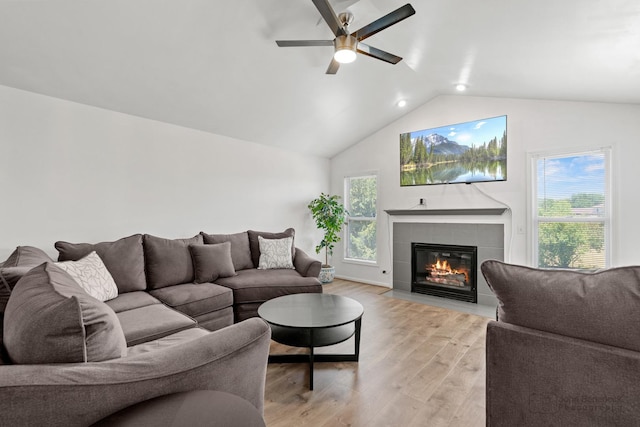 516 Madison Ln, Elgin, IL 60123 - living room featuring vaulted ceiling, light wood-style floors, a ceiling fan, and a tiled fireplace