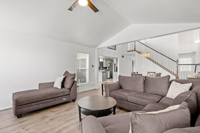 516 Madison Ln, Elgin, IL 60123 - living room featuring ceiling fan, light wood finished floors, stairway, high vaulted ceiling, and a chandelier