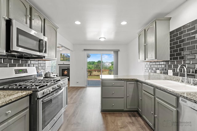 516 Madison Ln, Elgin, IL 60123 - kitchen featuring appliances with stainless steel finishes, gray cabinets, tasteful backsplash, and recessed lighting