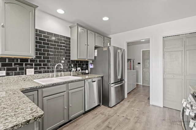 516 Madison Ln, Elgin, IL 60123 - kitchen with independent washer and dryer, stainless steel appliances, tasteful backsplash, light wood-style flooring, and recessed lighting