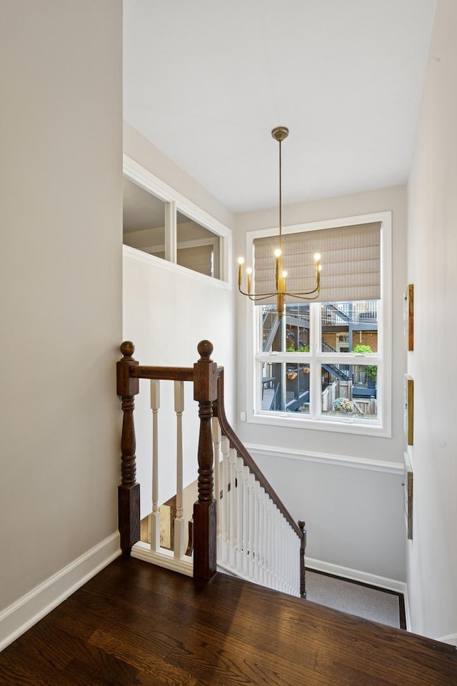 3547 N Fremont St Unit 1N, Chicago, IL 60657 - staircase featuring a chandelier and wood finished floors