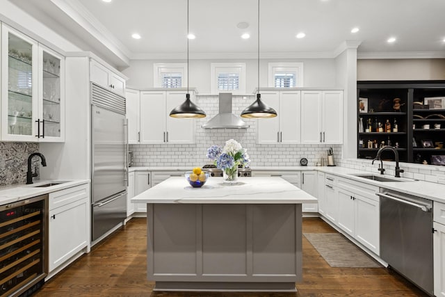 3547 N Fremont St Unit 1N, Chicago, IL 60657 - kitchen with wine cooler, appliances with stainless steel finishes, wall chimney range hood, ornamental molding, and tasteful backsplash