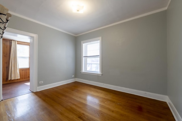 6712 N Maplewood Ave, Chicago, IL 60645 - empty room with wood finished floors, plenty of natural light, and crown molding