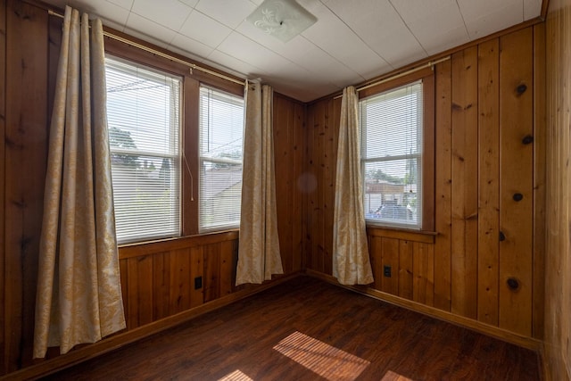 6712 N Maplewood Ave, Chicago, IL 60645 - spare room with wood walls and dark wood-style flooring