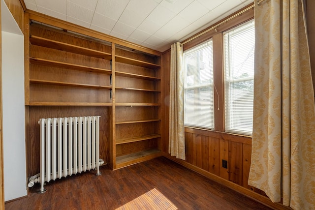 6712 N Maplewood Ave, Chicago, IL 60645 - unfurnished room with radiator heating unit, dark wood finished floors, and built in shelves
