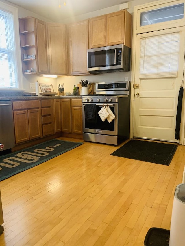 6712 N Maplewood Ave, Chicago, IL 60645 - kitchen with appliances with stainless steel finishes, open shelves, and light wood-style flooring