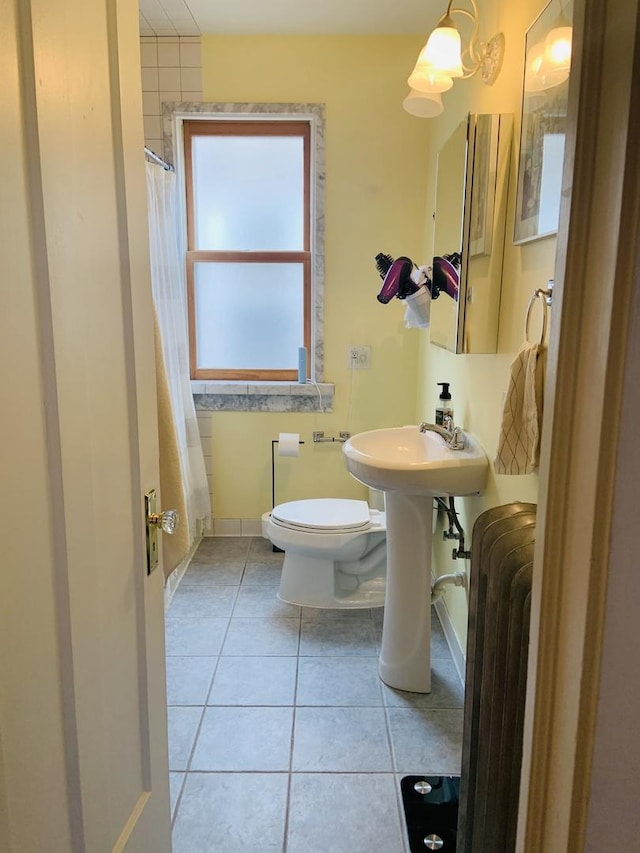 6712 N Maplewood Ave, Chicago, IL 60645 - bathroom featuring radiator, tile patterned floors, and a shower with curtain