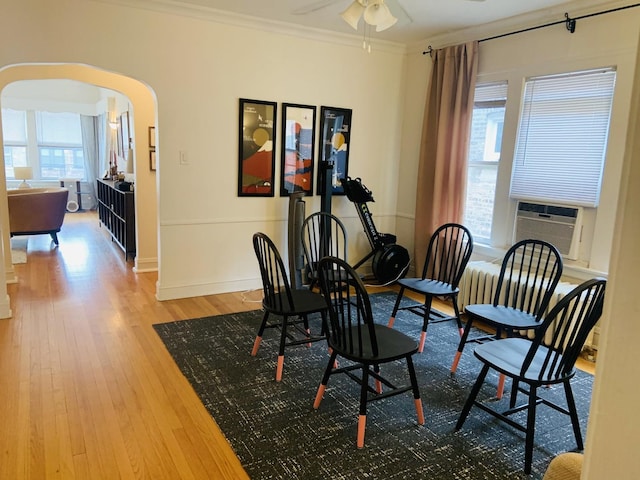 6712 N Maplewood Ave, Chicago, IL 60645 - dining space featuring arched walkways, wood finished floors, cooling unit, crown molding, and ceiling fan