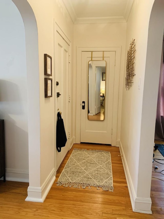 6712 N Maplewood Ave, Chicago, IL 60645 - corridor featuring arched walkways, light wood finished floors, and ornamental molding