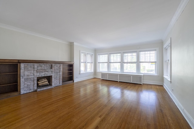 6712 N Maplewood Ave, Chicago, IL 60645 - unfurnished living room with radiator, wood finished floors, ornamental molding, and a fireplace